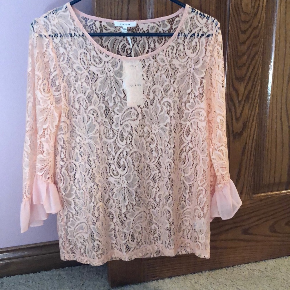 Peach lace top with bell sleeves.